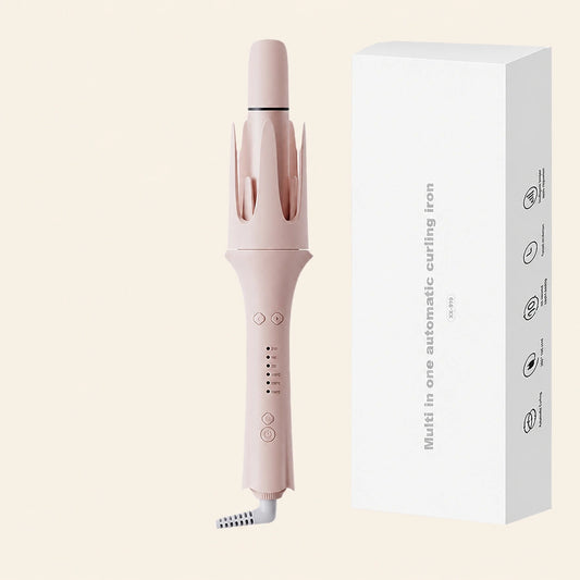 A light pink multi-functional automatic curling iron shown next to its white product packaging box on a solid pale beige background.