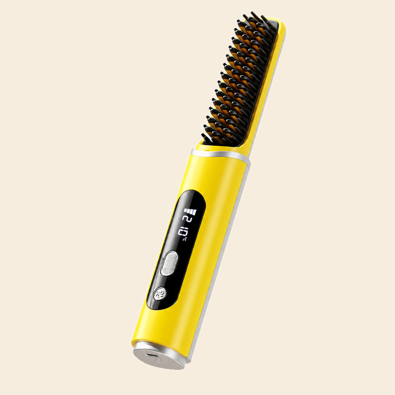 A yellow and silver hair straightener brush with a digital temperature display on the handle, set against a solid light beige background.