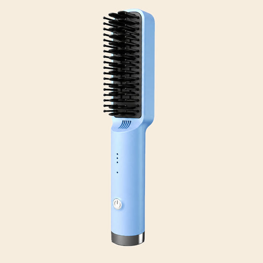 A light blue heated hair straightener brush with black bristles, shown vertically against a solid pale beige background.